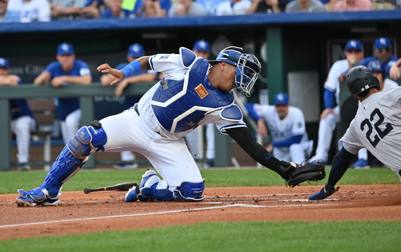 Jun 11, 2024; Kansas City, Missouri, USA; Kansas City Royals catcher Salvador Perez (13) is late with the tag on New York Yankees right fielder Juan Soto (22) at home plate in the first inning at Kauffman Stadium. Mandatory Credit: Peter Aiken-USA TODAY Sports