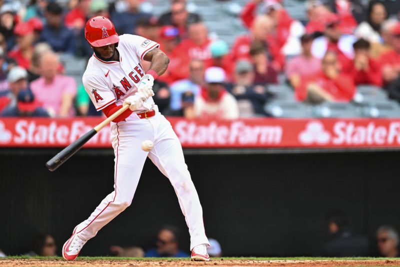 May 4, 2025; Anaheim, California, USA; Los Angeles Angels second baseman Tim Anderson (77) singles against the Detroit Tigers during the fifth inning at Angel Stadium. Mandatory Credit: Jonathan Hui-Imagn Images