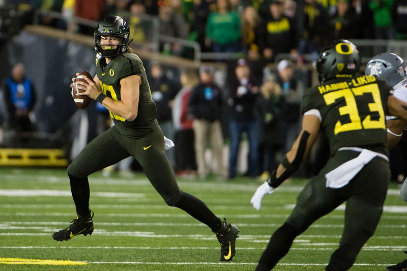 Oct 26, 2019; Eugene, OR, USA; Oregon Ducks quarterback Justin Herbert (10) rolls out to pass the ball against the Washington State Cougars during the first half at Autzen Stadium. Mandatory Credit: Troy Wayrynen-USA TODAY Sports