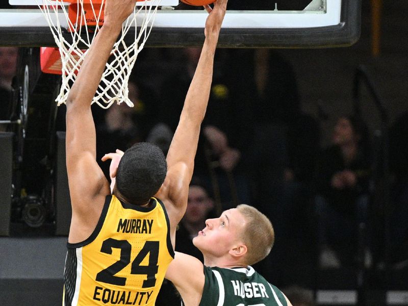 Feb 25, 2023; Iowa City, Iowa, USA; Michigan State Spartans forward Joey Hauser (10) defends the shot of Iowa Hawkeyes forward Kris Murray (24) during the first half at Carver-Hawkeye Arena. Mandatory Credit: Jeffrey Becker-USA TODAY Sports