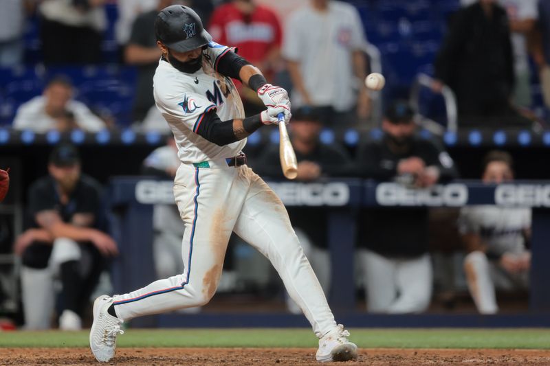 May 19, 2025; Miami, Florida, USA; Miami Marlins center fielder Derek Hill (3) hits a ground-rule double against the Chicago Cubs during the ninth inning at loanDepot Park. Mandatory Credit: Sam Navarro-Imagn Images