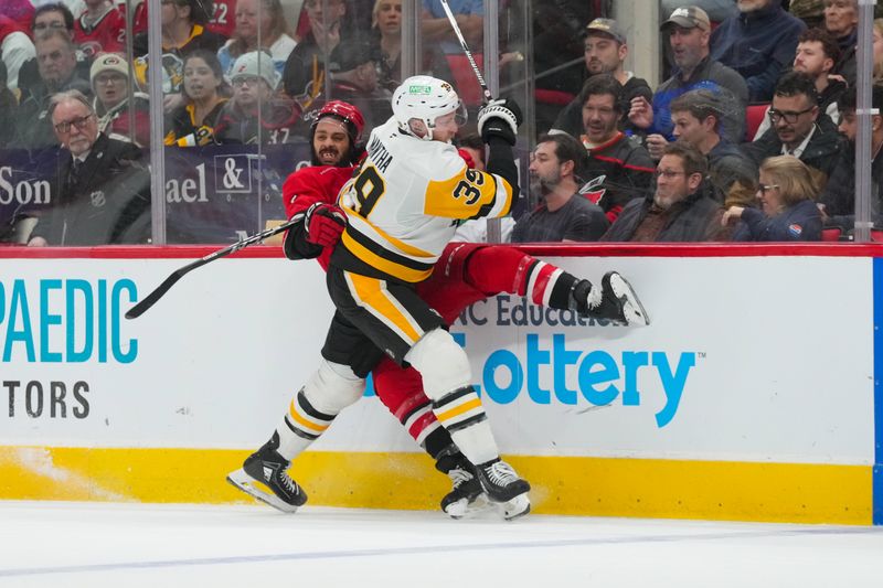 Mar 18, 2026; Raleigh, North Carolina, USA;  Pittsburgh Penguins right wing Anthony Mantha (39) checks Carolina Hurricanes defenseman Jalen Chatfield (5) during the second period at Lenovo Center. Mandatory Credit: James Guillory-Imagn Images