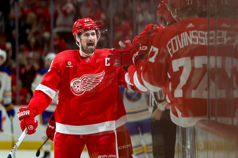 Apr 7, 2024; Detroit, Michigan, USA; Detroit Red Wings center Dylan Larkin (71) receives congratulations from teammates after scoring in the first period against the Buffalo Sabres at Little Caesars Arena. Mandatory Credit: Rick Osentoski-USA TODAY Sports