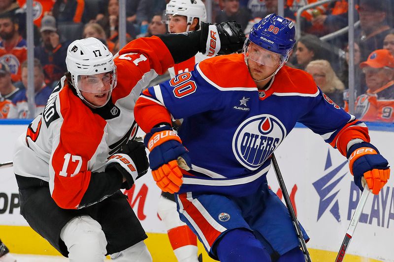 Oct 15, 2024; Edmonton, Alberta, CAN; Edmonton Oilers forward Corey Perry (90) and Philadelphia Flyers forward Jett Luchanko (17) chase a loose puck during the second period at Rogers Place. Mandatory Credit: Perry Nelson-Imagn Images