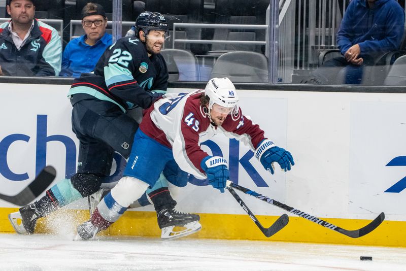 Oct 22, 2024; Seattle, Washington, USA;  Seattle Kraken forward Oliver Bjorkstrand (22) battles Colorado Avalanche defenseman Sam Malinski (70) during the second period at Climate Pledge Arena. Mandatory Credit: Stephen Brashear-Imagn Images