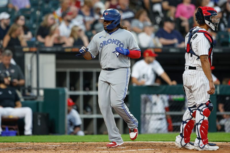 Jul 4, 2023; Chicago, Illinois, USA; Toronto Blue Jays first baseman Vladimir Guerrero Jr. (27) scores against the Chicago White Sox during the fourth inning at Guaranteed Rate Field. Mandatory Credit: Kamil Krzaczynski-USA TODAY Sports