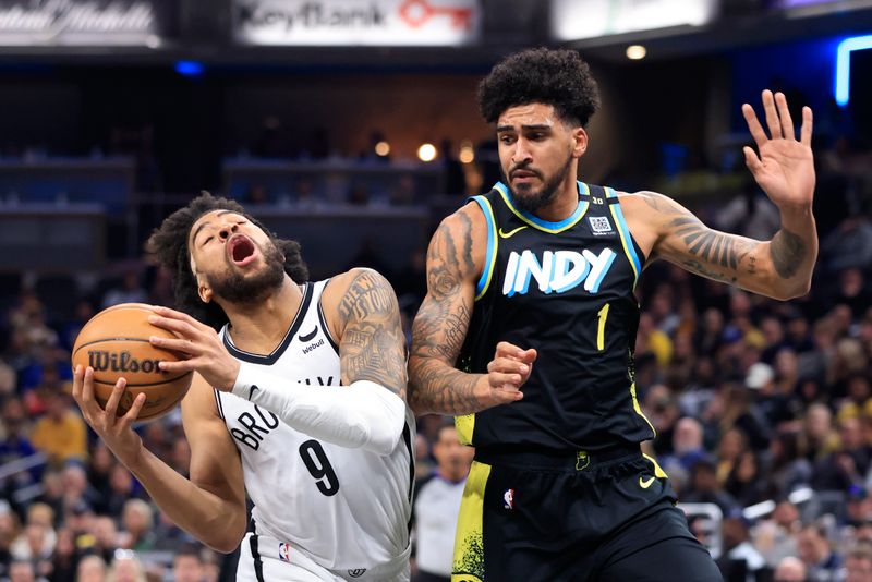 INDIANAPOLIS, INDIANA - MARCH 16: Trendon Watford #9 of the Brooklyn Nets  goes to the basket against Obi Toppin #1 of the Indiana Pacers during the first half at Gainbridge Fieldhouse on March 16, 2024 in Indianapolis, Indiana. NOTE TO USER: User expressly acknowledges and agrees that, by downloading and or using this photograph, User is consenting to the terms and conditions of the Getty Images License Agreement. (Photo by Justin Casterline/Getty Images)