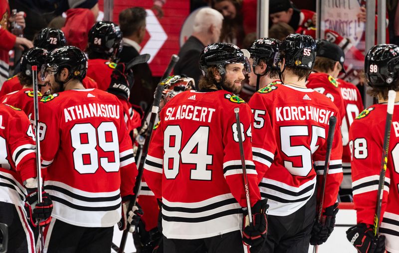 Apr 6, 2024; Chicago, Illinois, USA; Chicago Blackhawks left winger Landon Slaggert (84) celebrates with teammates after defeating the Dallas Stars at United Center. Mandatory Credit: Seeger Gray-USA TODAY Sports