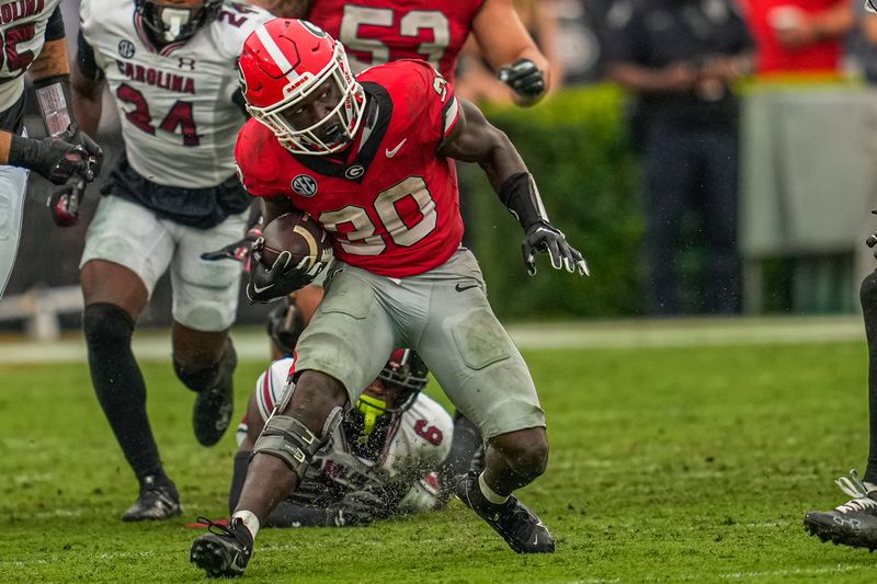 Sep 16, 2023; Athens, Georgia, USA; Georgia Bulldogs running back Daijun Edwards (30) runs with the ball against the South Carolina Gamecocks during the second half at Sanford Stadium. Mandatory Credit: Dale Zanine-USA TODAY Sports