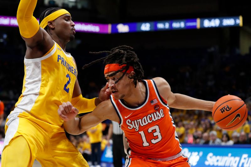 Jan 16, 2024; Pittsburgh, Pennsylvania, USA; Syracuse Orange forward Benny Williams (13) handles the ball against Pittsburgh Panthers forward Blake Hinson (2) during the second half at the Petersen Events Center. Syracuse won 69-58. Mandatory Credit: Charles LeClaire-USA TODAY Sports