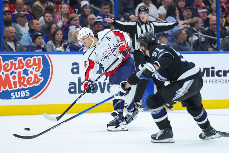 Nov 8, 2025; Tampa, Florida, USA; Washington Capitals defenseman John Carlson (74) shoots the puck against the Tampa Bay Lightning in the second period at Benchmark International Arena. Mandatory Credit: Nathan Ray Seebeck-Imagn Images
