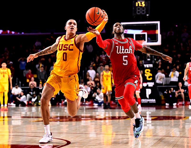 Feb 15, 2024; Los Angeles, California, USA; Southern California Trojans guard Kobe Johnson (0) and Utah Utes guard Deivon Smith (5) vie for the ball during the second half of an NCAA basketball game at Galen Center. Mandatory Credit: Alex Gallardo-USA TODAY Sports