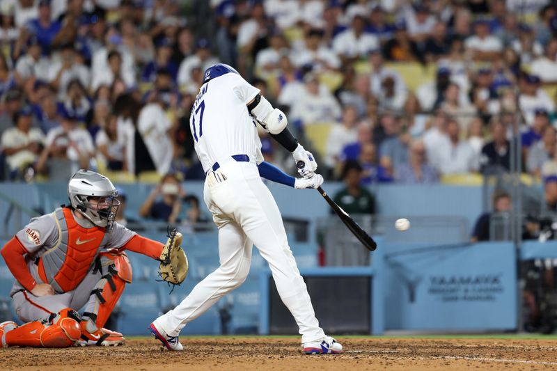 Sep 18, 2025; Los Angeles, California, USA;  Los Angeles Dodgers designated hitter Shohei Ohtani (17) hits a double during the eighth inning against the San Francisco Giants at Dodger Stadium. Mandatory Credit: Kiyoshi Mio-Imagn Images