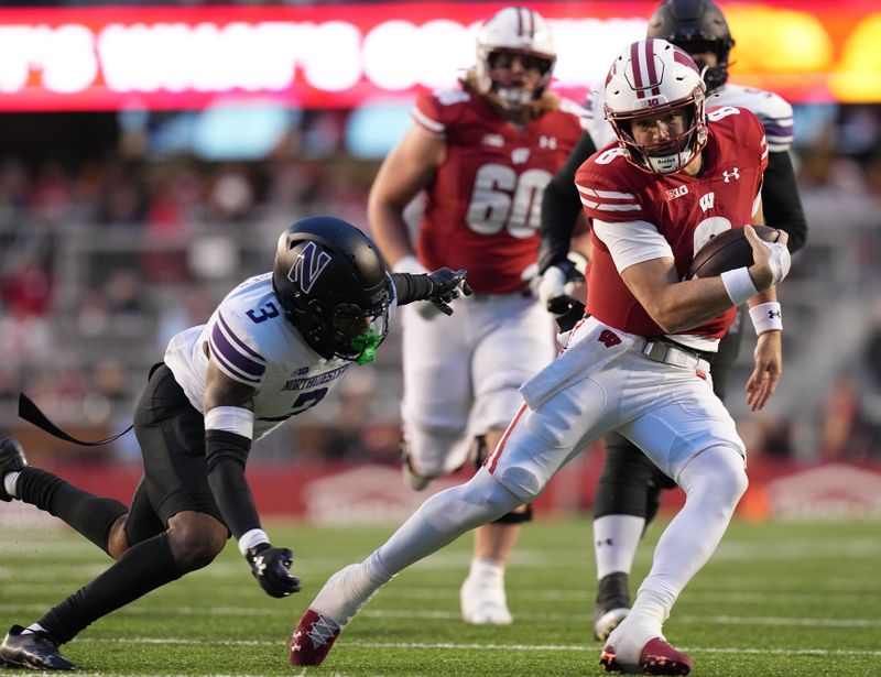 Nov 11, 2023; Madison, Wisconsin, USA; Wisconsin quarterback Tanner Mordecai (8) runs for a first down against the Northwestern Wildcats during the third quarter at Camp Randall Stadium. Mandatory Credit: Mark Hoffman-USA TODAY Sports