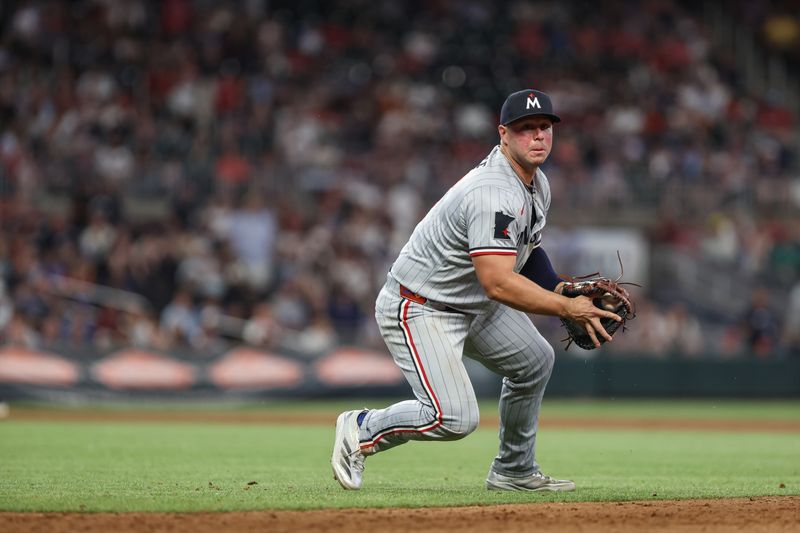 Apr 18, 2025; Cumberland, Georgia, USA; Minnesota Twins first baseman Ty France (13) fields the ball against the Atlanta Braves during the seventh inning at Truist Park. Mandatory Credit: Jordan Godfree-Imagn Images