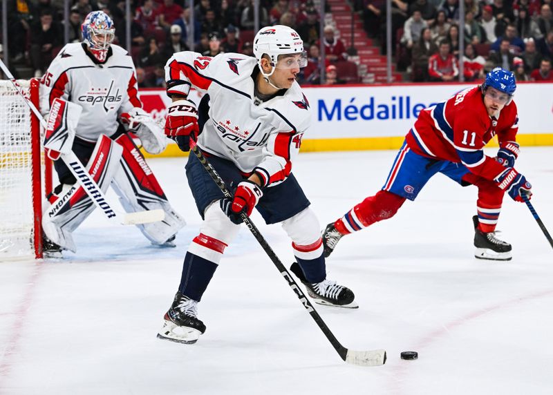 Oct 21, 2023; Montreal, Quebec, CAN; Washington Capitals defenseman Martin Fehervary (42) plays the puck against Montreal Canadiens right wing Brendan Gallagher (11) during the second period at Bell Centre. Mandatory Credit: David Kirouac-USA TODAY Sports