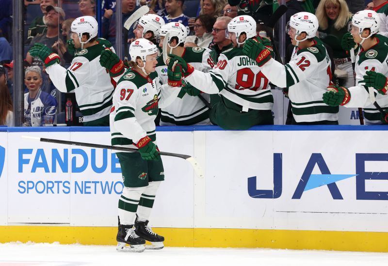 Oct 24, 2024; Tampa, Florida, USA; Minnesota Wild left wing Kirill Kaprizov (97) is congratulated by teammates after he scored a goal against the Tampa Bay Lightning during the first period at Amalie Arena. Mandatory Credit: Kim Klement Neitzel-Imagn Images