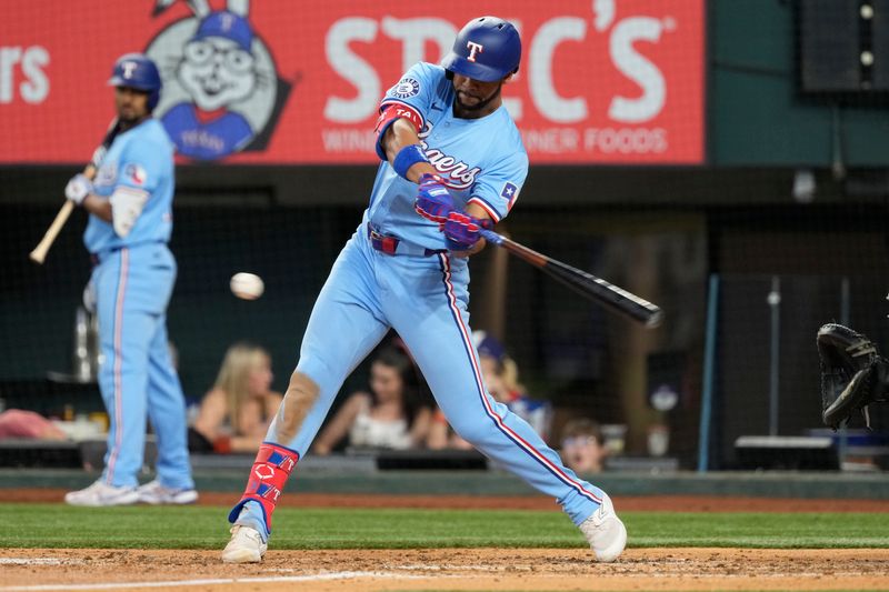 Jun 23, 2024; Arlington, Texas, USA; Texas Rangers center fielder Leody Taveras (3) hits a two-run double against the Kansas City Royals during the fourth inning at Globe Life Field. Mandatory Credit: Jim Cowsert-USA TODAY Sports