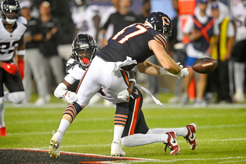 Chicago Bears linebacker Micah Baskerville (47) fumbles the ball as he is hit by Houston Texans safety Calen Bullock, center left, after making a catch during the first half of an NFL exhibition Hall of Fame football game, in Canton, Ohio, Thursday, Aug. 1, 2024. The Bears recovered the fumble. (AP Photo/Gene J. Puskar)