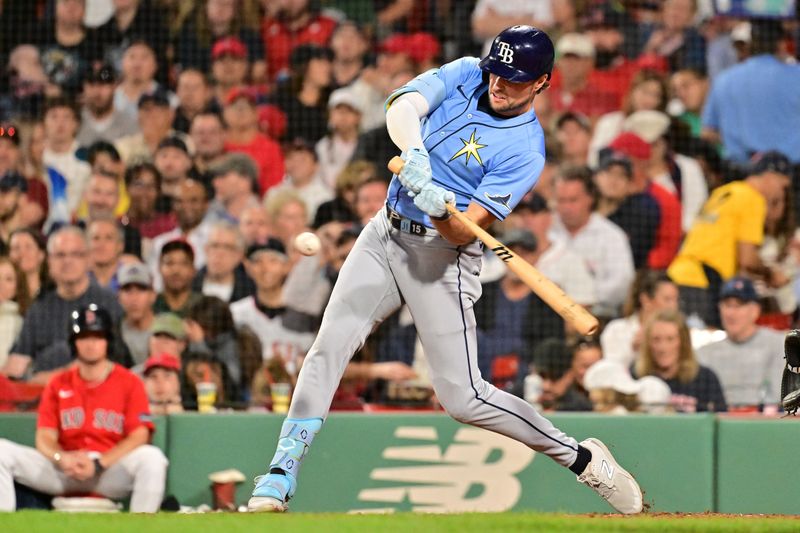 Sep 27, 2024; Boston, Massachusetts, USA; Tampa Bay Rays right fielder Josh Lowe (15) hits an RBI double against the Boston Red Sox during the seventh inning at Fenway Park. Mandatory Credit: Eric Canha-Imagn Images