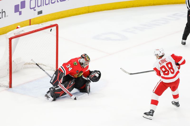 Feb 25, 2024; Chicago, Illinois, USA; Detroit Red Wings right wing Patrick Kane (88) shoots and scores game winning goal against Chicago Blackhawks goaltender Petr Mrazek (34) in overtime at United Center. Mandatory Credit: Kamil Krzaczynski-USA TODAY Sports