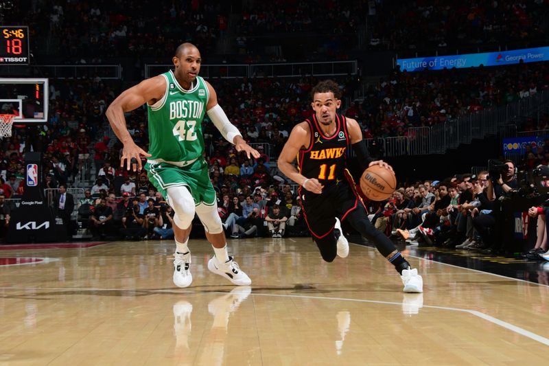 ATLANTA, GA - APRIL 23: Trae Young #11 of the Atlanta Hawks dribbles the ball during Round One Game Four of the 2023 NBA Playoffs against the Boston Celtics on April 23, 2023 at State Farm Arena in Atlanta, Georgia.  NOTE TO USER: User expressly acknowledges and agrees that, by downloading and/or using this Photograph, user is consenting to the terms and conditions of the Getty Images License Agreement. Mandatory Copyright Notice: Copyright 2023 NBAE (Photo by Scott Cunningham/NBAE via Getty Images)