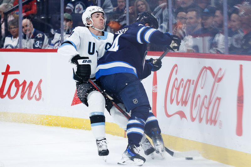 Nov 5, 2024; Winnipeg, Manitoba, CAN;  Winnipeg Jets defenseman Josh Morrissey (44) battles Utah Hockey Club forward Clayton Keller (9) for the puck during the first period at Canada Life Centre. Mandatory Credit: Terrence Lee-Imagn Images