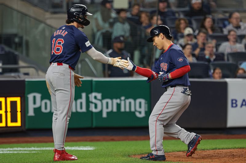 Sep 13, 2024; Bronx, New York, USA; Boston Red Sox left fielder Masataka Yoshida (7) celebrates with center fielder Jarren Duran (16) after hitting a three run home run during the sixth inning against the New York Yankees at Yankee Stadium. Mandatory Credit: Vincent Carchietta-Imagn Images