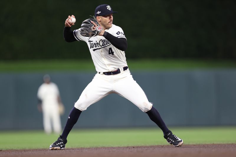 Oct 11, 2023; Minneapolis, Minnesota, USA; Minnesota Twins shortstop Carlos Correa (4) fields a ground ball in the third inning against the Houston Astros during game four of the ALDS for the 2023 MLB playoffs at Target Field. Mandatory Credit: Jesse Johnson-USA TODAY Sports