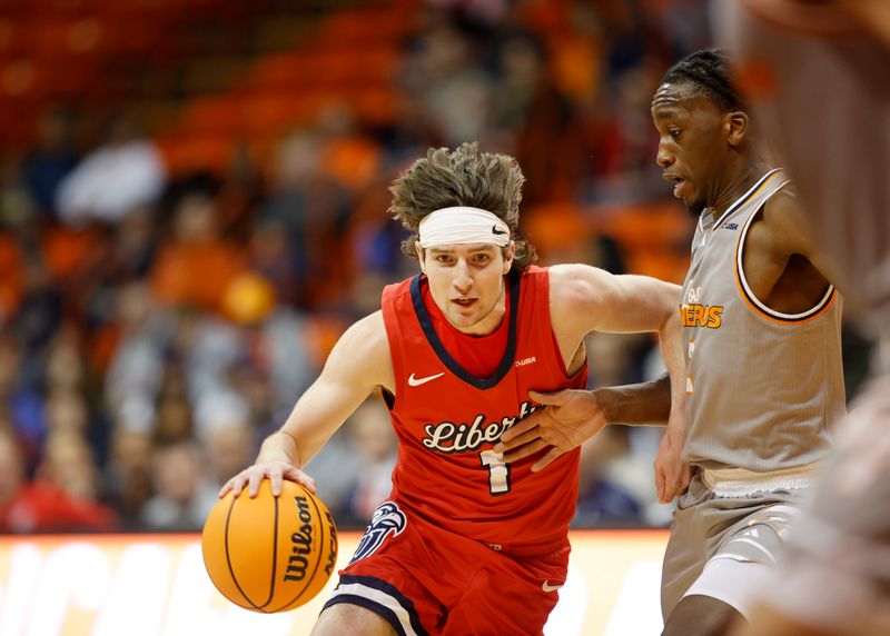 Feb 3, 2024; El Paso, Texas, USA; Liberty University Flames guard Brody Peebles (1) dribbles the ball against the UTEP Miners defense in the first half at Don Haskins Center. Mandatory Credit: Ivan Pierre Aguirre-USA TODAY Sports