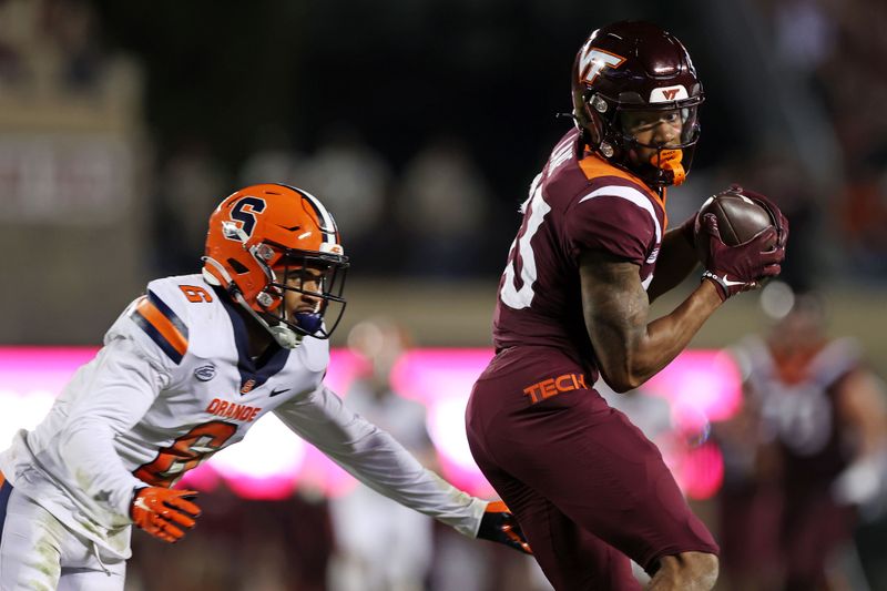 Oct 26, 2023; Blacksburg, Virginia, USA; Virginia Tech Hokies wide receiver Jaylin Lane (83) catches a pass against Syracuse Orange defensive back Jason Simmons Jr. (6) during the second quarter at Lane Stadium. Mandatory Credit: Peter Casey-USA TODAY Sports