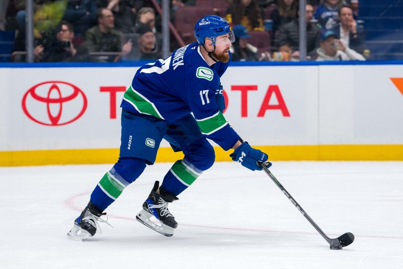 Jan 16, 2025; Vancouver, British Columbia, CAN; Vancouver Canucks defenseman Filip Hronek (17) handles the puck against the Los Angeles Kings in the third period at Rogers Arena. Mandatory Credit: Bob Frid-Imagn Images