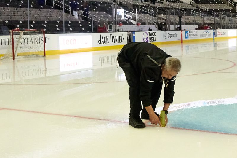 Mar 23, 2024; San Jose, California, USA; A worker prepares the ice surface before the game between the San Jose Sharks and the Chicago Blackhawks at SAP Center at San Jose. Mandatory Credit: Robert Edwards-USA TODAY Sports