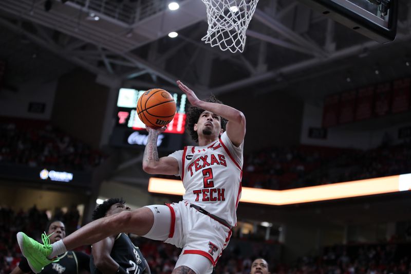 Feb 10, 2024; Lubbock, Texas, USA;  Texas Tech Red Raiders guard Pop Isaacs (2) goes to the basket against Central Florida Knights guard Jaylin Sellers (24) in the first half United Supermarkets Arena. Mandatory Credit: Michael C. Johnson-USA TODAY Sports