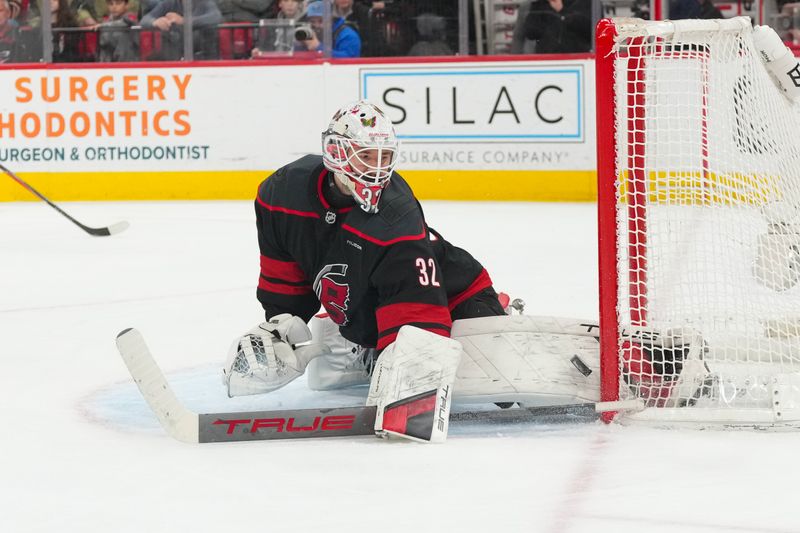 Jan 19, 2026; Raleigh, North Carolina, USA;  Carolina Hurricanes goaltender Brandon Bussi (32) makes a pad save against the Buffalo Sabres during the second period at Lenovo Center. Mandatory Credit: James Guillory-Imagn Images