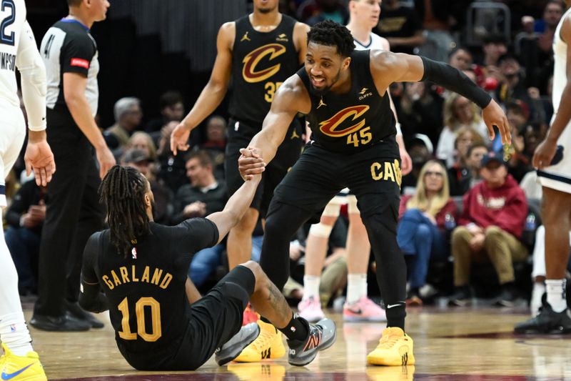 CLEVELAND, OHIO - APRIL 10: Donovan Mitchell #45 of the Cleveland Cavaliers helps up Darius Garland #10 during the second half against the Memphis Grizzlies at Rocket Mortgage Fieldhouse on April 10, 2024 in Cleveland, Ohio. NOTE TO USER: User expressly acknowledges and agrees that, by downloading and or using this photograph, User is consenting to the terms and conditions of the Getty Images License Agreement. (Photo by Nick Cammett/Getty Images)