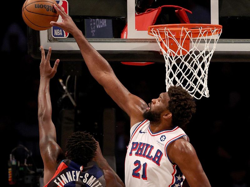 NEW YORK, NEW YORK - NOVEMBER 19:  Joel Embiid #21 of the Philadelphia 76ers blocks a shot from Dorian Finney-Smith #28 of the Brooklyn Nets in the second half at Barclays Center on November 19, 2023 in the Brooklyn borough of New York City. The Philadelphia 76ers defeated the Brooklyn Nets 121-99. NOTE TO USER: User expressly acknowledges and agrees that, by downloading and or using this photograph, User is consenting to the terms and conditions of the Getty Images License Agreement. (Photo by Elsa/Getty Images)