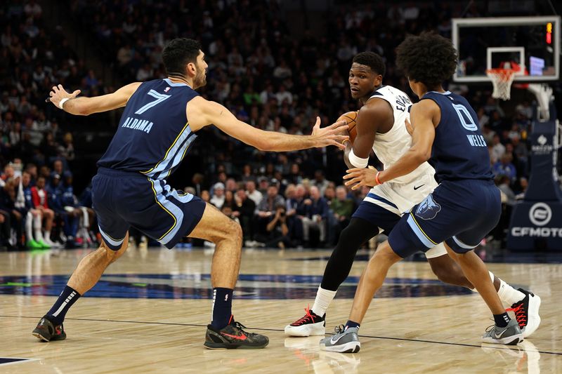 MINNEAPOLIS, MINNESOTA - JANUARY 11: Anthony Edwards #5 of the Minnesota Timberwolves handles the ball against Santi Aldama #7 and Jaylen Wells #0 of the Memphis Grizzlies in the first quarter at Target Center on January 11, 2025 in Minneapolis, Minnesota. NOTE TO USER: User expressly acknowledges and agrees that, by downloading and or using this photograph, User is consenting to the terms and conditions of the Getty Images License Agreement. (Photo by David Berding/Getty Images)