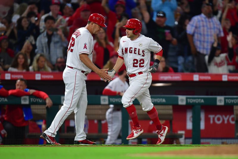 Sep 15, 2023; Anaheim, California, USA; Los Angeles Angels second baseman David Fletcher (22) is greeted by third base coach Bill Haselman (82) after hitting a solo home run against the Detroit Tigers during the seventh inning at Angel Stadium. Mandatory Credit: Gary A. Vasquez-USA TODAY Sports