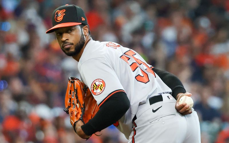 Jun 23, 2024; Houston, Texas, USA; Baltimore Orioles relief pitcher Dillon Tate (55) checks the runner at first base against the Houston Astros in the sixth inning at Minute Maid Park. Mandatory Credit: Thomas Shea-USA TODAY Sports