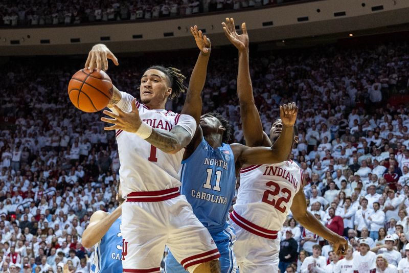 Nov 30, 2022; Bloomington, Indiana, USA; Indiana Hoosiers guard Jalen Hood-Schifino (1) rebounds the ball while North Carolina Tar Heels guard D'Marco Dunn (11) defends in the second half  at Simon Skjodt Assembly Hall. Mandatory Credit: Trevor Ruszkowski-USA TODAY Sports