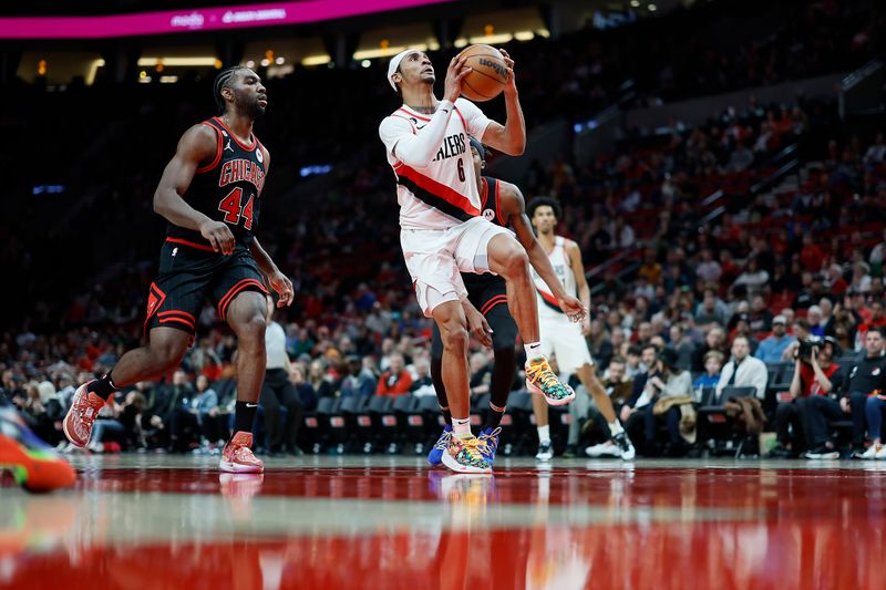 PORTLAND, OREGON - MARCH 24: Keon Johnson #6 of the Portland Trail Blazers drives to the basket past Patrick Williams #44 of the Chicago Bulls during the second half at Moda Center on March 24, 2023 in Portland, Oregon. NOTE TO USER: User expressly acknowledges and agrees that, by downloading and or using this photograph, User is consenting to the terms and conditions of the Getty Images License Agreement. (Photo by Soobum Im/Getty Images)