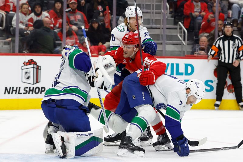 Dec 1, 2024; Detroit, Michigan, USA;  Vancouver Canucks goaltender Kevin Lankinen (32) makes a save on Detroit Red Wings right wing Christian Fischer (36) in the second period at Little Caesars Arena. Mandatory Credit: Rick Osentoski-Imagn Images