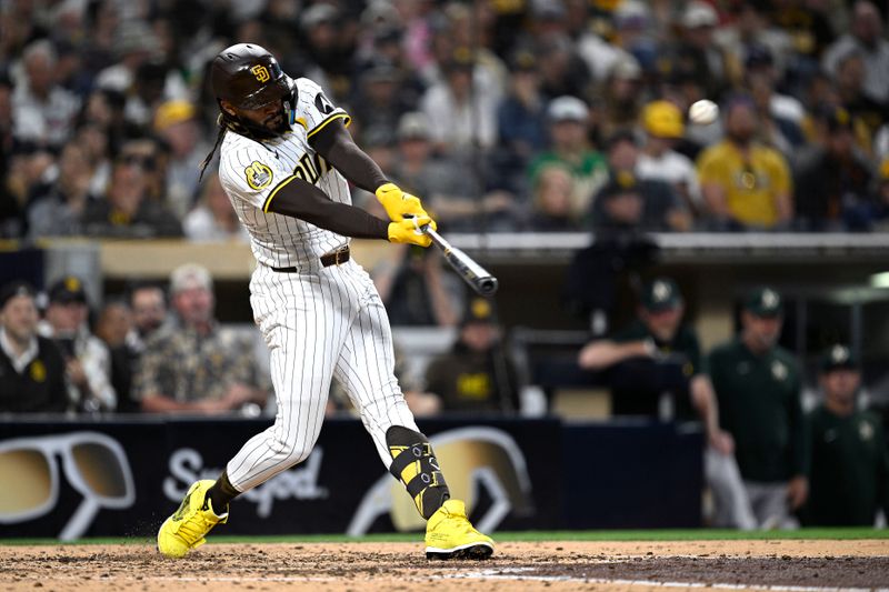 Jun 10, 2024; San Diego, California, USA; San Diego Padres right fielder Fernando Tatis Jr. (23) hits a home run against the Oakland Athletics during the fifth inning at Petco Park. Mandatory Credit: Orlando Ramirez-USA TODAY Sports