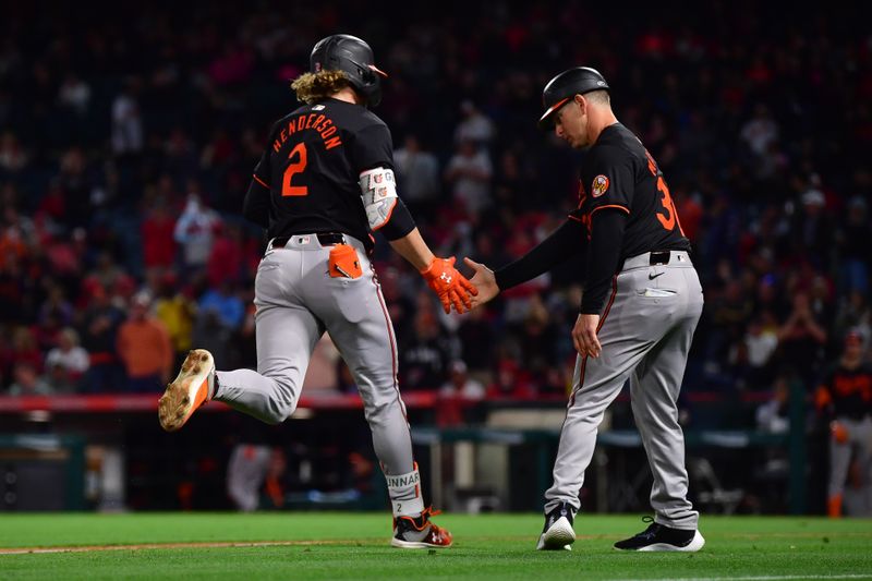 Apr 23, 2024; Anaheim, California, USA; Baltimore Orioles shortstop Gunnar Henderson (2) is greeted by third base coach Tony Mansolino (36) after hitting a solo home run against the Los Angeles Angels during the seventh inning at Angel Stadium. Mandatory Credit: Gary A. Vasquez-USA TODAY Sports