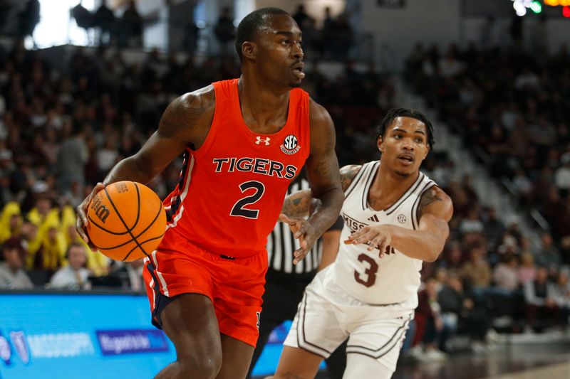 Jan 27, 2024; Starkville, Mississippi, USA; Auburn Tigers forward Jaylin Williams (2) drives to the basket as Mississippi State Bulldogs guard Shakeel Moore (3) defends during the first half at Humphrey Coliseum. Mandatory Credit: Petre Thomas-USA TODAY Sports