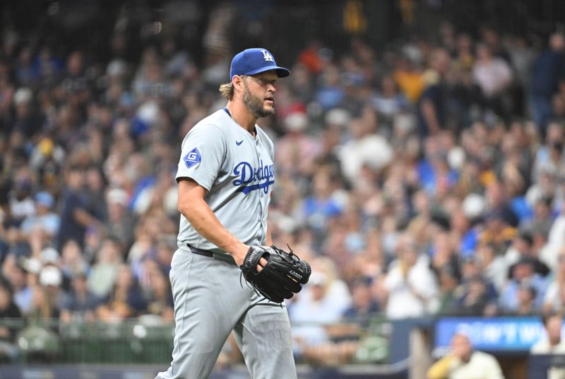 Aug 12, 2024; Milwaukee, Wisconsin, USA; Los Angeles Dodgers pitcher Clayton Kershaw (22) walks off the field after Los Angeles Dodgers manager Dave Roberts (30) took him out of the game in the sixth inning against the Milwaukee Brewers at American Family Field. Mandatory Credit: Michael McLoone-USA TODAY Sports