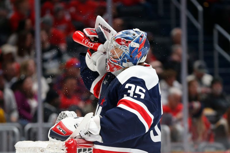 Jan 7, 2024; Washington, District of Columbia, USA; Washington Capitals goaltender Darcy Kuemper (35) squirts water in his face during a stoppage in play against the Los Angeles Kings in the first period at Capital One Arena. Mandatory Credit: Amber Searls-USA TODAY Sports