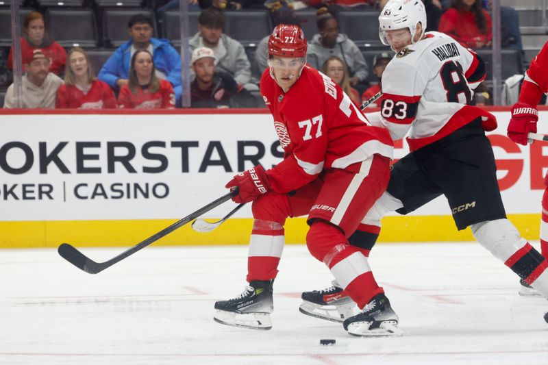 Oct 4, 2024; Detroit, Michigan, USA;  Detroit Red Wings defenseman Simon Edvinsson (77) skates with the puck in the third period against the Ottawa Senators at Little Caesars Arena. Mandatory Credit: Rick Osentoski-Imagn Images