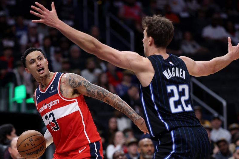 WASHINGTON, DC - MARCH 06: Kyle Kuzma #33 of the Washington Wizards reacts as he looks to pass in front of Franz Wagner #22 of the Orlando Magic during the first half at Capital One Arena on March 06, 2024 in Washington, DC. NOTE TO USER: User expressly acknowledges and agrees that, by downloading and or using this photograph, User is consenting to the terms and conditions of the Getty Images License Agreement. (Photo by Patrick Smith/Getty Images)